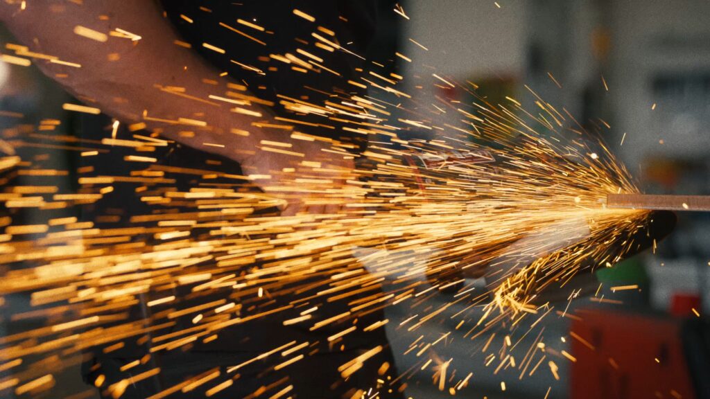 industrieumgebung-metallbearbeitung-winkelschleifer-funkenflug-close-up-produktvideo-b-roll-imagefilm-dreh-handwerk-fertigung